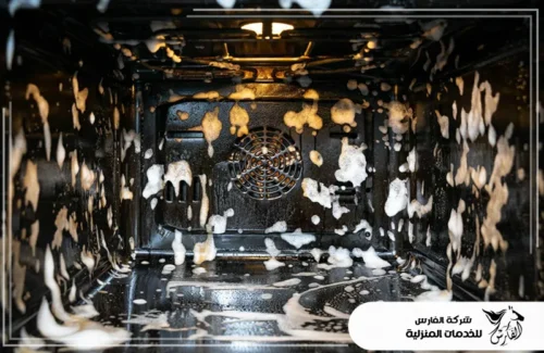 تنظيف فرن الغاز من الداخل في الرياض 0557756533 شركة الفارس لقطة داخل الفرن تظهر رغوة منظف التنظيف تغطي الجدران والزوايا.